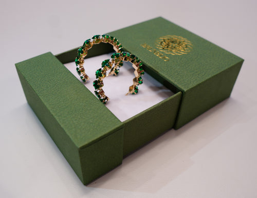 Golden earrings with green crystals
