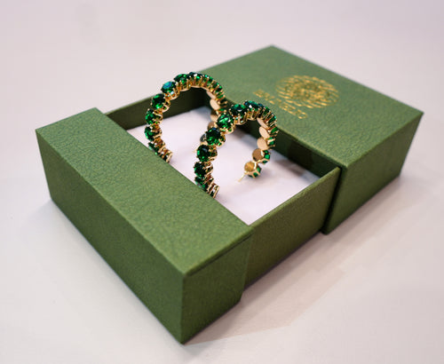 Golden earrings with green diamonds