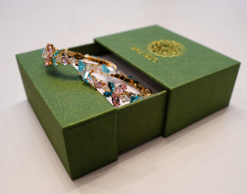 Round gold earrings with colored diamonds