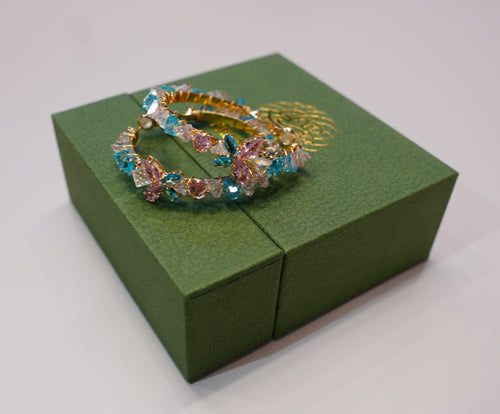 Round gold earrings with colored diamonds