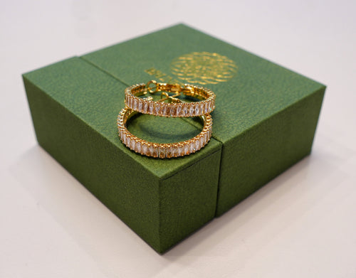 Round gold earrings with silver and white diamonds