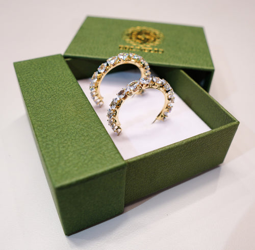 Round gold earrings with silver and white diamonds